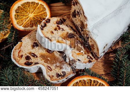 Christmas Stollen On Wooden Background. Traditional Christmas German Dessert Cut Into Pieces. Cake W