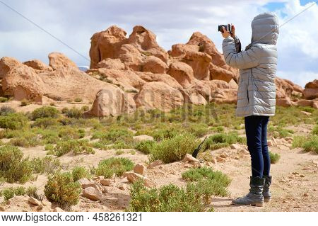 Female Traveler Shooting Photos Of Amazing Landscape With Plenty Of Rock Formations In Siloli Desert