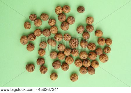 Top View Of Chufa, Tigernut, Earth Almond On Green Background. Nuts For Traditional Homemade Cold Fr