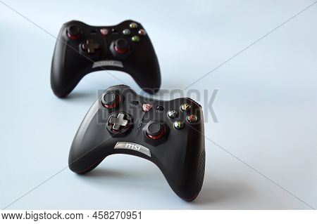 Two Msi Joystick Gaming Controller On Light Blue Background.