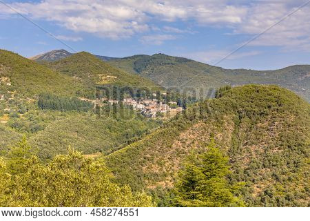 Forested Mountains Of Cevennes With Small Village Of Saint Andre De Majencoules In The Hills. Occita