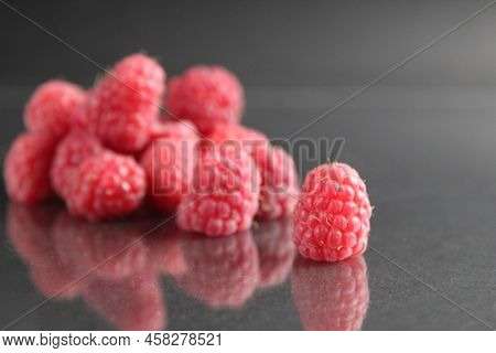 Raspberries Lie In A Stack Of Piles On A Black Background Close-up. Day Berries Health Raspberries F