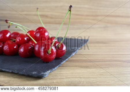 Cherries On A Black Tray On The Table. Ripe Berry Close-up. Growing Cherry Berries Healthy Eating He