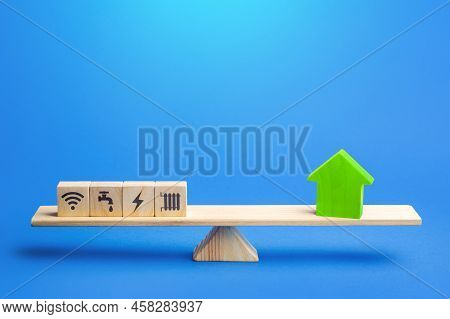 House And Utilities On The Scales. Providing Home Amenities. Electricity, Heating, Water And Gas. Ma