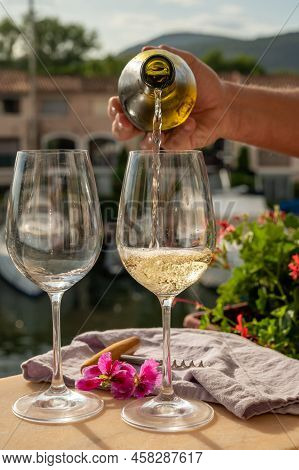 Pouring In Glasses Of Cold White Wine In Yacht Harbour Of Port Grimaud, Summer Vacation On French Ri