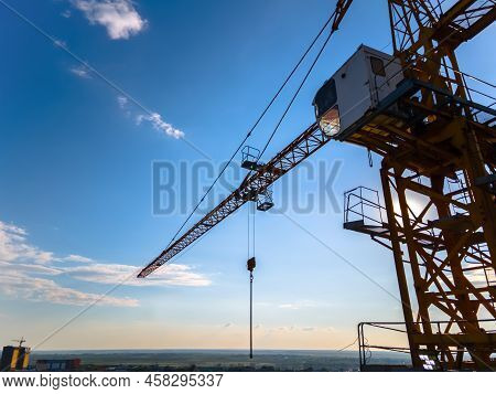 Construction Crane On The Background Of A Clear Day Sky Aerial View. Flyby Of A Construction Crane O