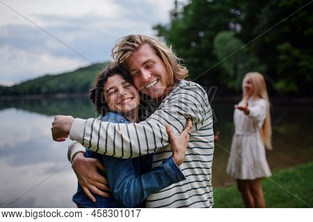 Friends Having Fun Together At Park Lauging And Hugging, Friendship And Lifestyle Concepts