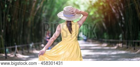 Asian Woman In Yellow Dress And Hat Traveling At Green Bamboo Tunnel, Happy Traveler Walking Chulabh