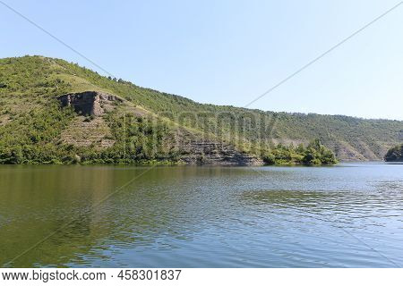 Dniester River Tributary, Ukraine. The Green Banks Of A Large River With Calm Water.
