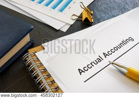 Documents About Accrual Accounting Near Notepad And Pen.