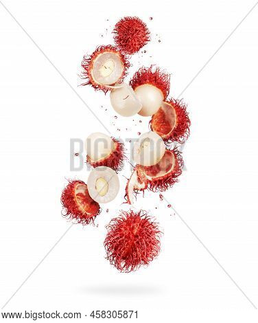 Whole And Crushed Rambutan Fruits In The Air On A White Background