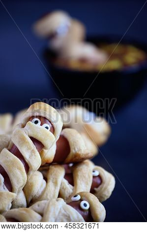 Fun Food For Kids. Mummy Hot Dogs (or Pigs In A Blanket) On A Blue Rustic Table With A Bowl Of Ketch