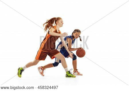 Studio Shot Of Beginner Basketball Players, Young Girls, Teen Training With Basketball Ball Isolated