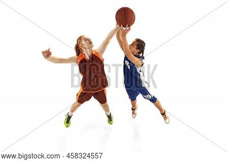 Play Defense. Two Basketball Players, Young Girls, Teen Training With Basketball Ball Isolated On Wh