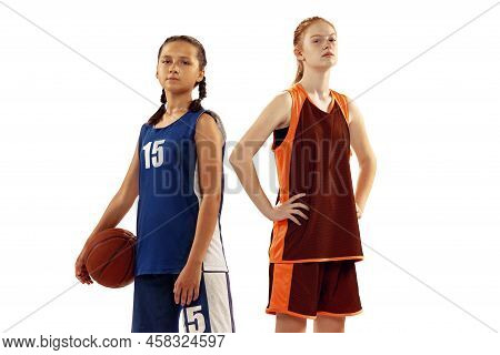 Portrait Of Two Young Girls, Basketball Players Posing With Basketball Ball Isolated On White Backgr