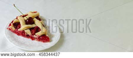 A Piece Of Homemade Cherry Pie With Flaky Crust On A White Saucer On A White Tablecloth On The Table