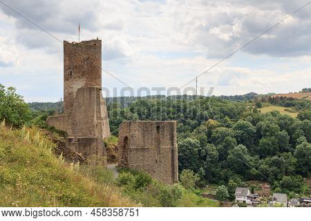 Panorama View Of Ruins Of Castle Loewenburg On A Hill Spur And Eifel Village Monreal, Germany