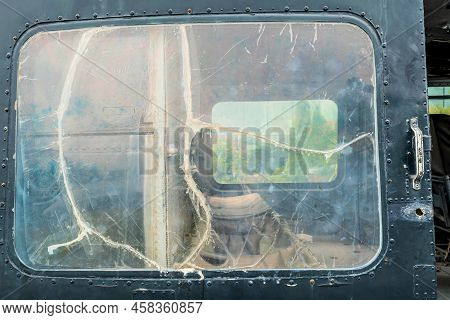 Jeju City, South Korea; June 20, 2022: Closeup Of Cracked Door Window In Bell Uh-1b Helicopter At Mu