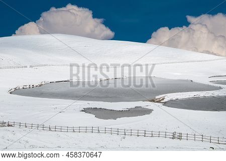 View Of Frozen Lakes With Snowy Mountains