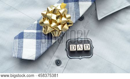 Gift Of Shirt Tie And Beautiful Golden Circular Strips For Dad.