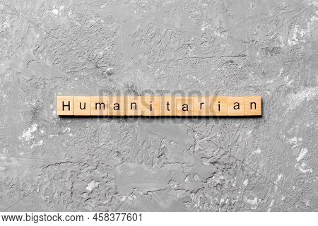 Humanitarian Word Written On Wood Block. Humanitarian Text On Table, Concept.