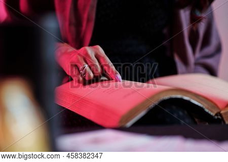 Close-up Image Of Witch Reading Spell In Old Book To Exorcise The Evil Spirit