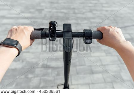Electric Scooter Handle Bar Holding By Habds With Smart Display On Grey Background