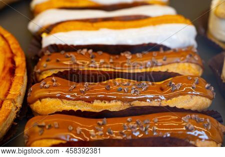 French Sweet Dessert Filled With Cream Fresh Baked Eclers Cakes  Close Up