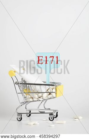 Titanium Dioxide, E171, Dangerous Additive Concept. Gum, Pills, Toothpaste, Cream In Basket And Sign