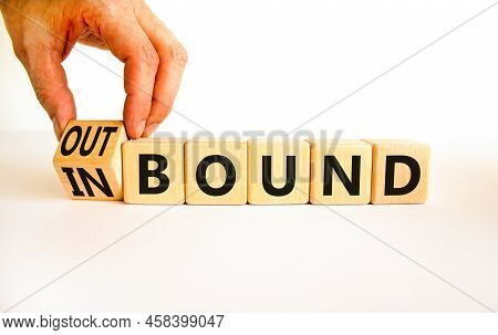 Inbound Or Outbound Symbol. Businessman Turns Wooden Cubes And Changes The Concept Word Outbound To 