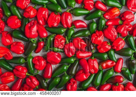 Background Of Colorful Jalapeno And Habanero Peppers On Light Background