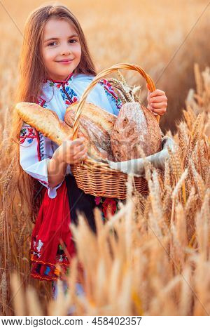 Bulgarian Woman Or Young Girl In Traditional Folklore Dress Holds In Hands Golden Wheat And Freshly 