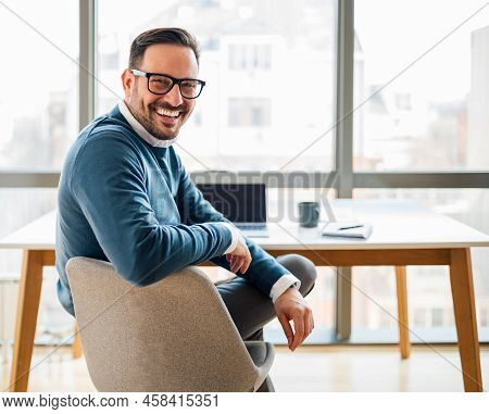 Portrait Of Young Smiling Happy Handsome Successful Businessman Entrepreneur Freelancer Working From