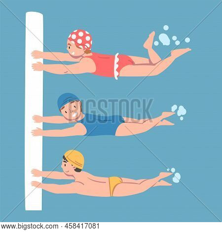Kids Learning To Swim In Swimming Pool. Children In Swimwear, Caps And Goggles Training At Swimming 