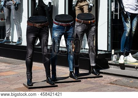 Three Half Mannequins With Dressed Jeans In Front Of A Shop Window. Men's Fashion Store.