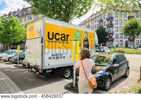 Strasbourg, France - Jun 27, 2015: Rear View Of French Woman Walking Near The Ucar Cargo Van During 
