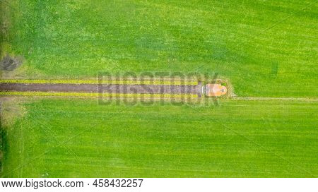 Garden Detail In Aerial View With Sand Path Going Between Two Hedges Towards A Little Building, A Sh