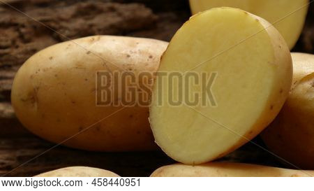 Fresh Solanum Tuberosum (potatoes,  Irish Potato) On Wooden Background.