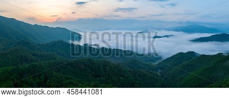 Panoramic View Looking Down On Early Morning Fog In Mountains As Sun Rises