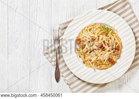 Delicious Capunti Pasta In Cream Pecorino Cheese And Pancetta Sauce On White Plate On White Wooden T