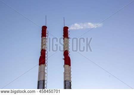 Air Pollution By Smoke Coming Out Of Two Factory Chimneys. Close-up From Below Of Smoke Coming Out O