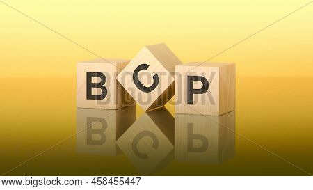 Bcp - Acronym Business Continuity Plan - Text Written On Wooden Cubes, Yellow Background, Business C