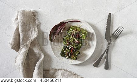 Rolls With Beet Leaves Served On The Plate With A Cutlary. A Vegetarian Cooking, Top View, Copy Spac