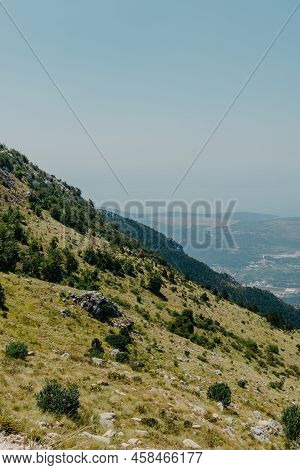 Panoramic View Of Idyllic Mountain Scenery In The Alps With Fresh Green Meadows In Bloom On A Beauti