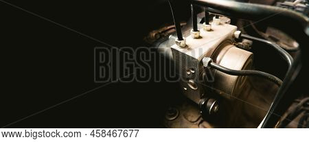 Abs Unit Module Control Box With Pipes Of A Car Brake System With Horizontal Copy Space On Black Bac