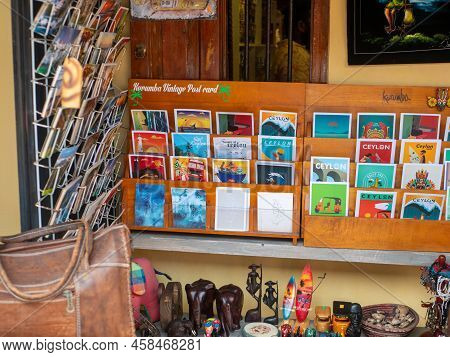 Galle, Sri Lanka - March 12, 2022: Souvenir Shop With Brightly Colored Postcards And Wooden Figurine