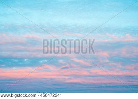 Beautiful Panorama Of Sky With Pink Clouds At Sunset Or Sunrise. Light Pink Clouds In Sunset Blue Sk