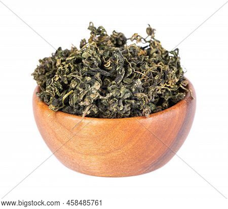 Dry Gynostemma Pentaphyllum Leaf In Wooden Bowl, Isolated On White Blackground. Jiaogulan Or Miracle