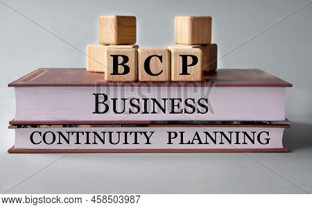 Bcp (business Continuity Planning) - Acronym On Wooden Cubes On The Background Of Recumbent Books. B