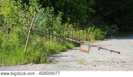 An Old Broken Barrier On An Abandoned Road